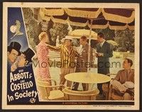 6d379 IN SOCIETY LC '44 Bud Abbott under umbrella looks at Lou Costello in wacky outfit!