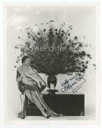 6s345 MYRNA LOY signed 8x10 REPRO still '80s sexy full-length portrait sitting by stuffed peacock!
