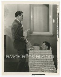 7b425 PARLOR BEDROOM & BATH 8x10 still '31 wacky image of man putting Buster Keaton in hamper!