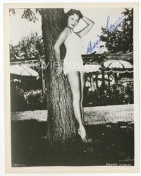 7c288 RHONDA FLEMING signed 8x10 REPRO still '80s standing in bathing suit leaning against tree!