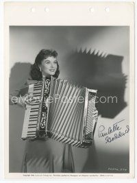 7c123 PAULETTE GODDARD signed key book still '40 playing accordian, which is her new hobby!