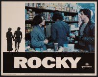 7s571 ROCKY LC #7 '77 Sylvester Stallone tries to talk to Talia Shire at the grocery store!