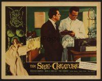 7s589 SHE-CREATURE LC #7 '56 Ron Randell and scientist study animal cage, cool border art!