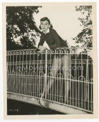 1m005 AUDREY HEPBURN 8.25x10 still '56 full-length with pigtails leaning over rail on bridge!