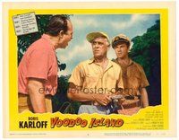 1x977 VOODOO ISLAND LC #8 '57 close up of Boris Karloff holding camera & arguing with two men!