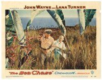 3h686 SEA CHASE LC #1 '55 John Wayne & Lana Turner walking through high grass on an island!