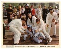 8j866 SPINOUT color English FOH LC '66 Elvis Presley on ground in racing helmet & jumpsuit!