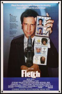 8z292 FLETCH advance 1sh '85 Michael Ritchie, wacky detective Chevy Chase has gun pulled on him!