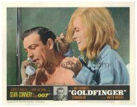 1c315 GOLDFINGER LC #2 '64 c/u of sexy Shirley Eaton behind Sean Connery as James Bond on phone!
