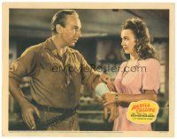 1s635 MANILA CALLING LC '42 pretty Carole Landis tends to Lloyd Nolan's wounded arm!