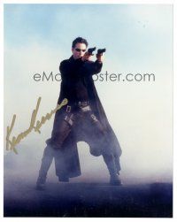 2a857 KEANU REEVES signed color 8x10 REPRO still '00s full-length as Neo with 2 guns in The Matrix!