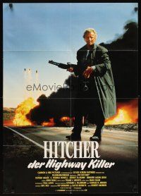 2b225 HITCHER German '86 image of Rutger Hauer with giant gun in front of explosions!