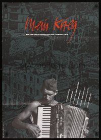 2b257 MY PRIVATE WAR German '90 Mein Krieg, image of soldier playing accordion!