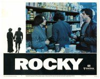 3e762 ROCKY LC #7 '76 Sylvester Stallone tries to talk to Talia Shire at the grocery store!