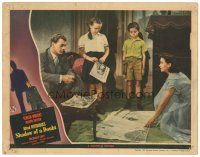 3e016 SHADOW OF A DOUBT LC '43 Joseph Cotten watches Teresa Wright spread newspapers on floor!