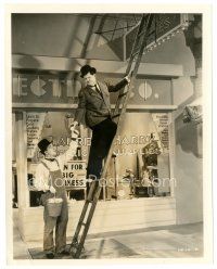 4b852 TIT FOR TAT 8x10 still '35 Stan Laurel hands light bulbs to Oliver Hardy on ladder!