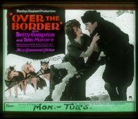 4e119 OVER THE BORDER glass slide '22 Betty Compson & Tom Moore + art of sled dogs!