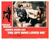 4d854 SPY WHO LOVED ME LC #5 '77 Barbara Bach holds Roger Moore at gunpoint he's opening champagne