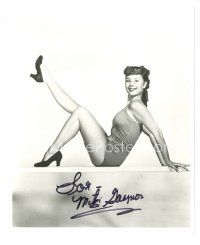 5a829 MITZI GAYNOR signed 8x10 REPRO still '80s full-length seated portrait kicking leg in air!