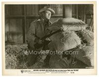 6m783 RIO BRAVO 8x10 still '59 John Wayne with rifle hiding behind feed bags in barn!