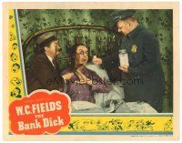 7d311 BANK DICK LC '40 W.C. Fields puts ping pong ball-sized medicine in Franklin Pangborn's mouth
