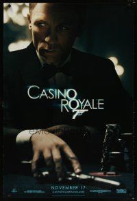 8b138 CASINO ROYALE teaser DS 1sh '06 Craig as James Bond sitting at poker table w/gun!