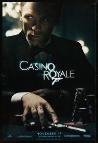 2b155 CASINO ROYALE teaser DS 1sh '06 Craig as James Bond sitting at poker table w/gun!