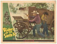 5j782 RIDERS OF THE SANTA FE LC '44 Rod Cameron fire his gun as Jennifer Holt reloads behind wagon!