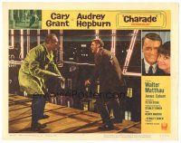 6h243 CHARADE LC #7 '63 close up of tough Cary Grant in fight with George Kennedy on roof!