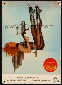 7c306 BARBARELLA German LC '68 sexiest Jane Fonda on her back with legs in the air & pointing gun!