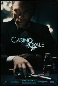 7d426 CASINO ROYALE teaser DS 1sh '06 Daniel Craig as James Bond sitting at poker table w/gun!