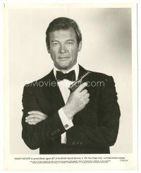 7d309 FOR YOUR EYES ONLY 8x10 still '81 great c/u of Roger Moore as James Bond in tuxedo with gun!
