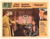 8p394 CHARADE LC #1 '63 c/u of Cary Grant pointing gun at James Coburn, directed by Stanley Donen