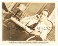 9y203 CONFLICT 8x10.25 still '45 c/u of Humphrey Bogart smoking while relaxing in wheelchair!