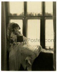 2z894 THEDA BARA deluxe 7.5x9.5 still '20s on a cushioned window seat w/ a book by St. Elmo Boyce!