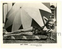 3y119 BETTY GRABLE 8x10.25 still '40s full-length laying on grass in swimsuit by umbrella!