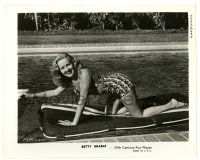 3y121 BETTY GRABLE 8x10.25 still '40s in two-piece swimsuit kneeling on floatation device in pool!