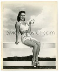 3y481 JANIS CARTER 8.25x10 still '53 sitting on a fence in sexy outfit holding sunglasses!