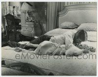 4b043 CARPETBAGGERS deluxe 10.5x13.25 still '64 George Peppard on bed w/ Carroll Baker in negligee!