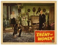 4w444 ENEMY OF WOMEN LC '44 H.B. Warner and woman stare at man crouching on carpet!