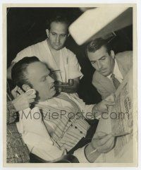 6a198 CITIZEN KANE candid 8.25x10 still '40 Orson Welles being made up & reading Inquirer by Kahle!
