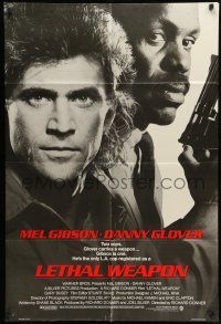 8p577 LETHAL WEAPON advance 1sh '87 great close image of cop partners Mel Gibson & Danny Glover!