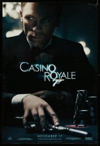 8w125 CASINO ROYALE teaser DS 1sh '06 Craig as James Bond sitting at poker table w/gun!