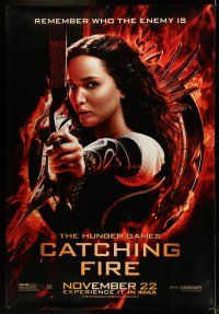 9j444 HUNGER GAMES: CATCHING FIRE DS bus stop '13 Jennifer Lawrence w/bow in logo!