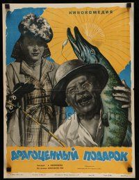 1j278 DRAGOTSENNYY PODAROK Russian 15x20 '56 Manukhin art of man w/fish & disapproving woman!
