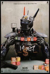 2z130 CHAPPIE teaser DS 1sh '15 close up image of the robot with toy blocks, huge necklace and gun!