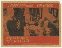 3k019 VERTIGO LC #5 '58 Alfred Hitchcock, standing James Stewart on phone,blonde Kim Novak in bed!