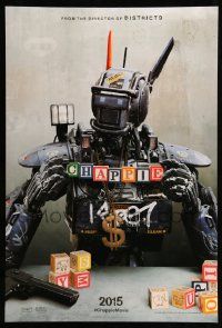 4k165 CHAPPIE teaser DS 1sh '15 close up image of the robot with toy blocks, huge necklace and gun!