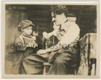 6d011 KID 8x10.25 still '21 close up of seated Charlie Chaplin smiling at Jackie Coogan!