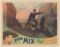 7c902 TERROR TRAIL LC '33 great close up of Tom Mix standing on rocks with his gun drawn!